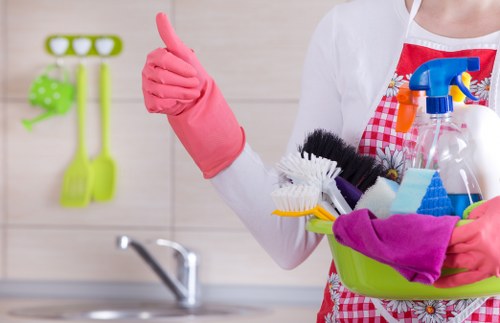 Professional carpet cleaner protecting furniture and flooring during work